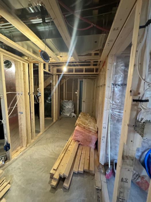 Before: Basement hall: framing to finished